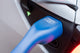 Close-up of a blue Voldt Type 2 EV charging cable connector in a white car's charging port